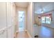 Hallway leads to a full bathroom and a living room with ample sunlight and plenty of storage at 7102 Silvermill Dr, Tampa, FL 33635