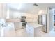 Updated kitchen featuring modern appliances, quartz countertops, and white cabinets at 7102 Silvermill Dr, Tampa, FL 33635