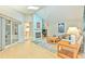 Open-concept living room with wood floors, fireplace, and natural light at 7102 Silvermill Dr, Tampa, FL 33635