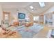 Inviting living room featuring vaulted ceilings, skylights, and a comfortable seating area at 7102 Silvermill Dr, Tampa, FL 33635