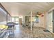 Inviting covered patio with stone tile flooring, ceiling fan, and views of the outdoor space at 7102 Silvermill Dr, Tampa, FL 33635