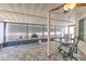 Relaxing screened patio with tile flooring, ceiling fan, and comfortable outdoor seating for al fresco dining at 7102 Silvermill Dr, Tampa, FL 33635