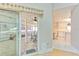 Charming sunroom, with stone flooring and a ceiling fan, viewed from the kitchen at 7102 Silvermill Dr, Tampa, FL 33635
