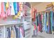 Organized walk-in closet with shelves, drawers, and hanging rods for ample storage at 7102 Silvermill Dr, Tampa, FL 33635