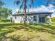 Inviting backyard featuring a well-maintained lawn and a covered patio, perfect for relaxation and outdoor entertaining at 1696 Bendix Ter, North Port, FL 34286