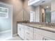 Bathroom featuring double vanity with granite countertop and walk-in shower at 1696 Bendix Ter, North Port, FL 34286