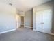 Bedroom with plush carpet and neutral walls, and doors leading to other spaces at 1696 Bendix Ter, North Port, FL 34286