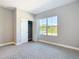 Neutral bedroom with closet, plush carpet, and bright window views at 1696 Bendix Ter, North Port, FL 34286