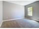 Neutral bedroom featuring plush carpet and bright natural light from a window at 1696 Bendix Ter, North Port, FL 34286
