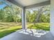 Spacious covered patio with views of the backyard, offering an ideal spot for relaxation and enjoying the outdoors at 1696 Bendix Ter, North Port, FL 34286