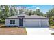 Charming single-story home featuring a three-car garage and beautifully landscaped front yard at 1696 Bendix Ter, North Port, FL 34286