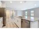 Kitchen island with granite countertops and stainless steel dishwasher at 1696 Bendix Ter, North Port, FL 34286