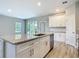Kitchen island with granite countertops and stainless steel dishwasher at 1696 Bendix Ter, North Port, FL 34286