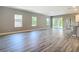 Bright, open living room featuring hardwood floors and sliding glass doors at 1696 Bendix Ter, North Port, FL 34286