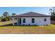 Backyard view of a new construction home with a covered patio at 2223 Hattie Ct, North Port, FL 34288