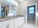 Stylish bathroom featuring double sinks with granite countertops and modern fixtures at 2223 Hattie Ct, North Port, FL 34288