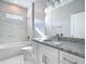 Bright bathroom with granite counters, white cabinets, and marble tile at 2223 Hattie Ct, North Port, FL 34288