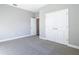 Bedroom featuring neutral carpet, gray walls, and a double door closet at 2223 Hattie Ct, North Port, FL 34288