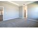 Spacious bedroom featuring neutral walls, plush carpeting, and a tray ceiling at 2223 Hattie Ct, North Port, FL 34288