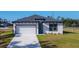 Charming single-Gathering home featuring a two-car garage and a well-maintained lawn at 2223 Hattie Ct, North Port, FL 34288