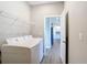 Laundry room with new washer and dryer units, with a view to the kitchen at 2223 Hattie Ct, North Port, FL 34288