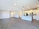 Open-concept living space featuring modern floors and a view of the kitchen and laundry area at 2223 Hattie Ct, North Port, FL 34288