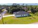 Aerial view of a single-Gathering home with lush landscaping on a spacious lot, showcasing its serene setting at 2423 Sadnet Ln, North Port, FL 34286