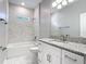 Bathroom featuring a tub, granite countertops, and a vanity with white cabinets at 2423 Sadnet Ln, North Port, FL 34286