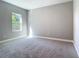 Bedroom featuring neutral tones, carpet flooring, and a window at 2423 Sadnet Ln, North Port, FL 34286