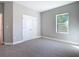 Bedroom featuring neutral tones, carpet flooring, a double-door closet and a window at 2423 Sadnet Ln, North Port, FL 34286