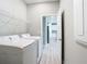 Functional laundry room with side-by-side washer and dryer connections and convenient shelving at 2423 Sadnet Ln, North Port, FL 34286