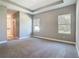 Spacious main bedroom with plush carpeting, neutral paint, and tray ceiling, creating a relaxing retreat at 2423 Sadnet Ln, North Port, FL 34286