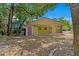 Exterior view of the green home highlighting the backyard, patio, and shed at 107 W Woodlawn Ave, Tampa, FL 33603