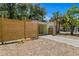 Private backyard partially enclosed by a stylish wood fence, offering a serene outdoor space at 107 W Woodlawn Ave, Tampa, FL 33603