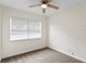 A cozy bedroom with a ceiling fan and a large window that provides natural light at 107 W Woodlawn Ave, Tampa, FL 33603