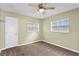 Bedroom featuring carpet, a ceiling fan, and two windows, providing natural light and ventilation at 107 W Woodlawn Ave, Tampa, FL 33603