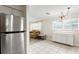 Bright dining area with a sideboard, and windows, seamlessly connected to the living room, and kitchen at 107 W Woodlawn Ave, Tampa, FL 33603