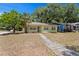 A cozy one-story home with tidy landscaping and healthy trees, perfect for suburban living at 107 W Woodlawn Ave, Tampa, FL 33603
