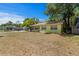 Quaint single-story home with a traditional design, showcasing its front lawn and mature trees at 107 W Woodlawn Ave, Tampa, FL 33603