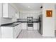 Spacious kitchen with stainless steel appliances, ample cabinet space, and tile flooring at 107 W Woodlawn Ave, Tampa, FL 33603