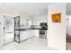 Modern kitchen with stainless steel appliances, white cabinets, and an open layout, perfect for cooking at 107 W Woodlawn Ave, Tampa, FL 33603