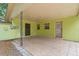 A covered patio offers ample space, tile flooring, and access to the backyard and utility areas at 107 W Woodlawn Ave, Tampa, FL 33603