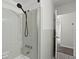 Bathroom shower featuring classic tile work, a showerhead and an open doorway at 107 W Woodlawn Ave, Tampa, FL 33603