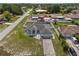 Aerial view of a well-maintained home with a two car garage, a fenced yard, and mature trees at 5188 Elwood Rd, Spring Hill, FL 34608