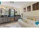 Bathroom featuring double sinks, vanity area, and large soaking tub at 5188 Elwood Rd, Spring Hill, FL 34608