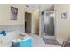 Bathroom featuring a shower, tub, and tiled flooring at 5188 Elwood Rd, Spring Hill, FL 34608