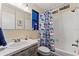 Bathroom with a shower-tub combo, decorative shower curtain, vanity, and coordinated decor at 5188 Elwood Rd, Spring Hill, FL 34608