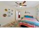 Bright bedroom with a ceiling fan, rug, and decorative accents creating a cozy, inviting space at 5188 Elwood Rd, Spring Hill, FL 34608