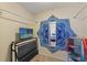 A storage closet with shelving, hanging rods, and a TV at 5188 Elwood Rd, Spring Hill, FL 34608