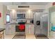 Updated kitchen featuring modern stainless steel appliances, gray cabinets, and stylish countertops at 5188 Elwood Rd, Spring Hill, FL 34608
